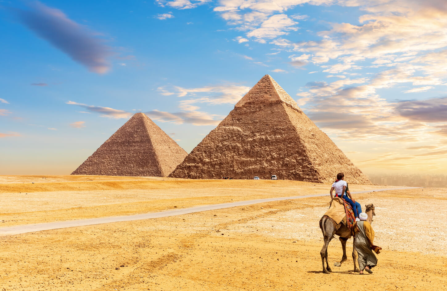 Some-tourists-ride-a-camel-in-front-of-the-pyramids-of-Giza 2 days in cairo
