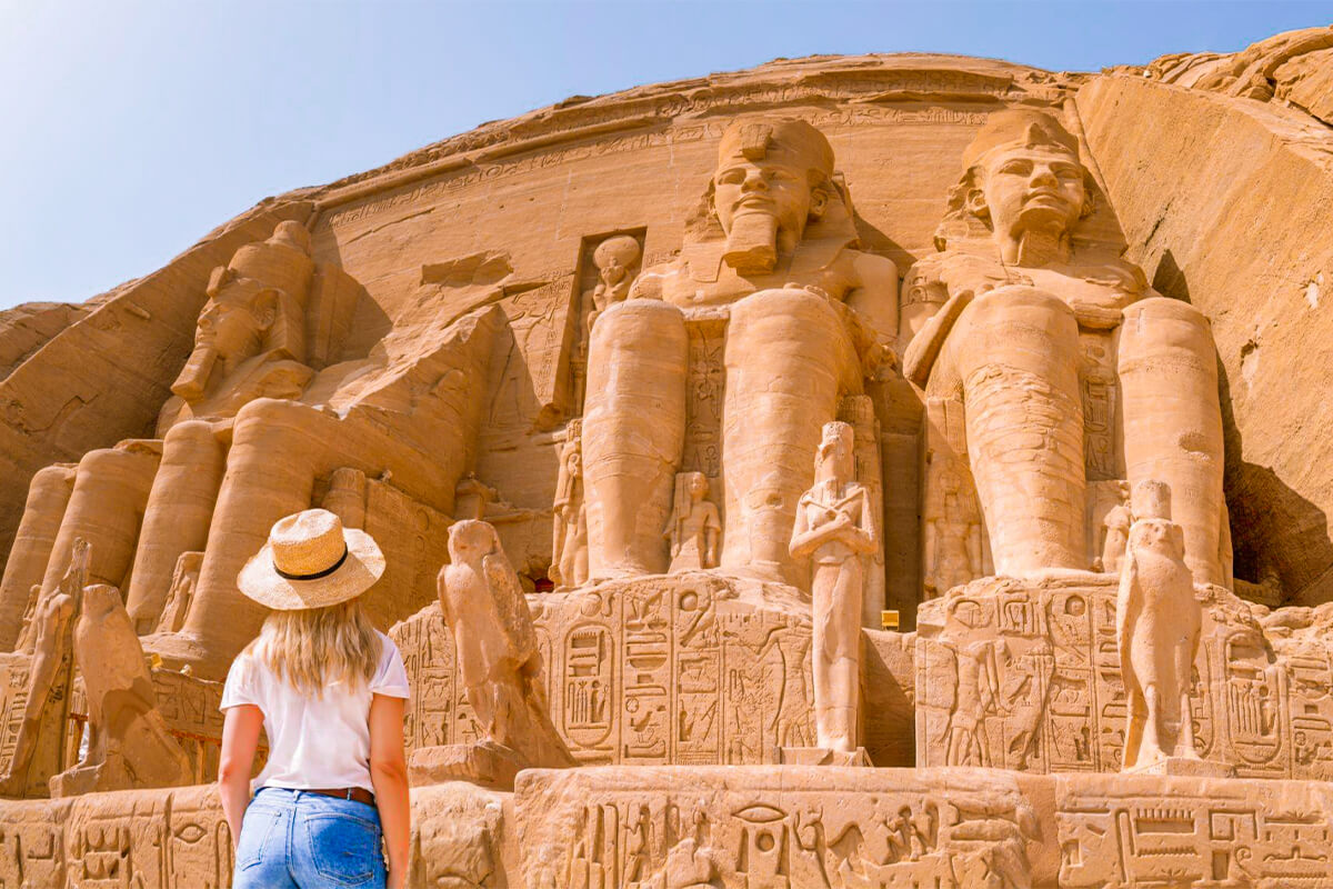 A-blonde-haired-woman-with-a-hat-stands-in-front-of-the-Abu-Simbel-temple-in-Egypt, 10 days egypt tour