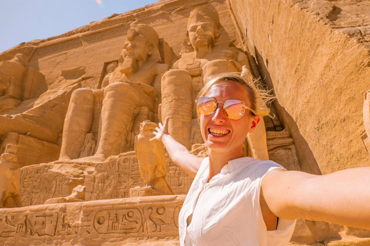 A-wonderful-view-of-a-female-tourist-taking-a-selfie-in-front-of-the-statues-of-Abu-Simbel-Temple-in-Aswan 6 days in egypt